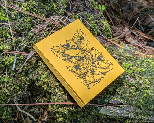 Yellow notepad featuring an illustration of a banana slug