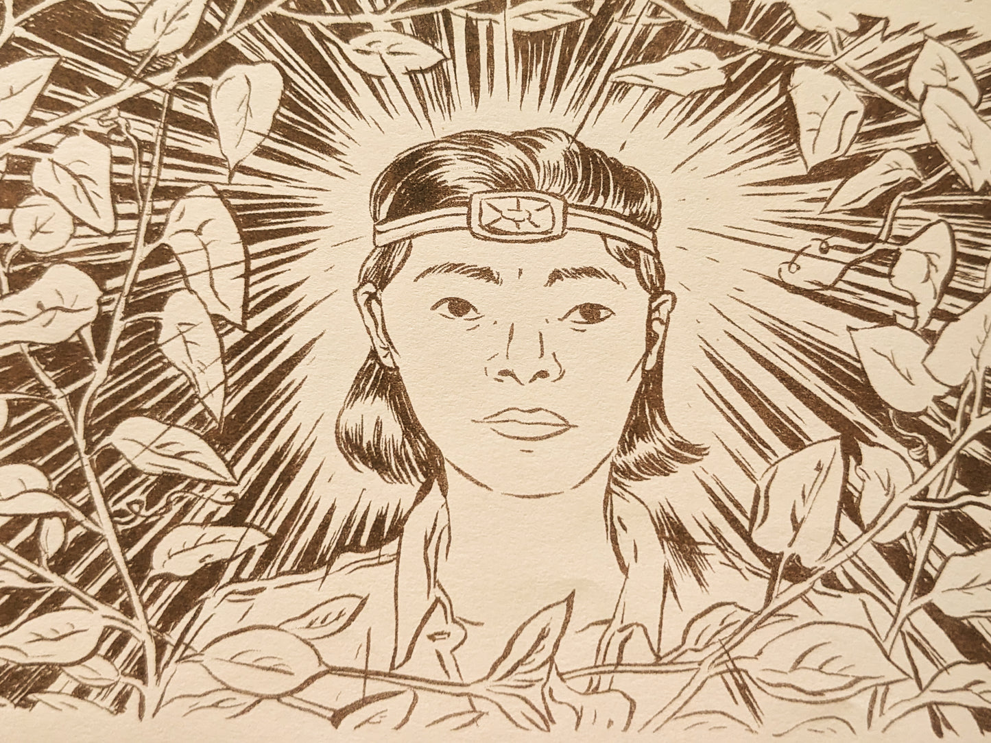 Detail from the comic of a woman surrounded by vines and looking at the viewer with a headlight shining bright.