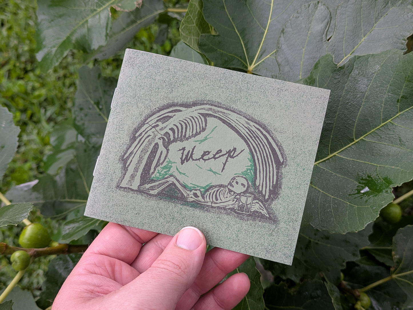 Cover image with a skeleton under a willow tree