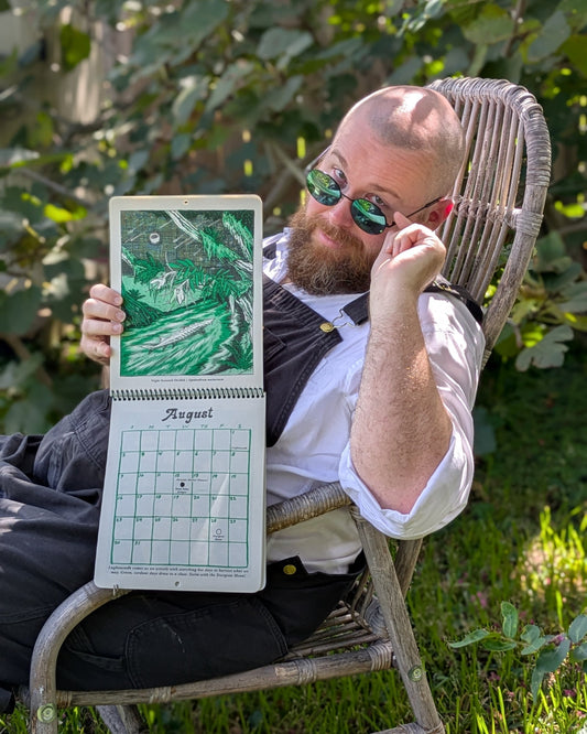 James previewing the august calendar image in a garden chair.