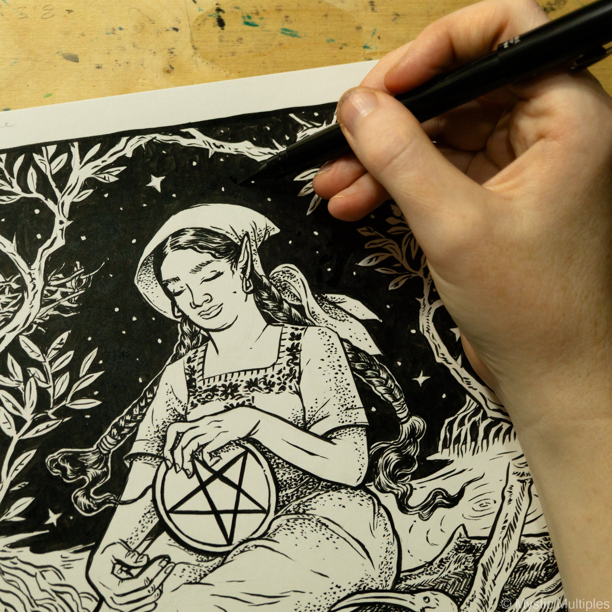 In progress shot of the queen of pentacles being drawn in black ink