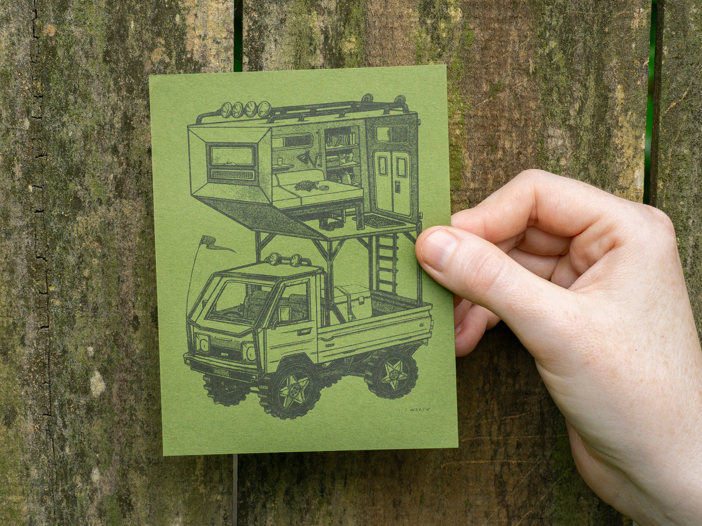 Kei truck art print on green paper held in front of a wooden fence.