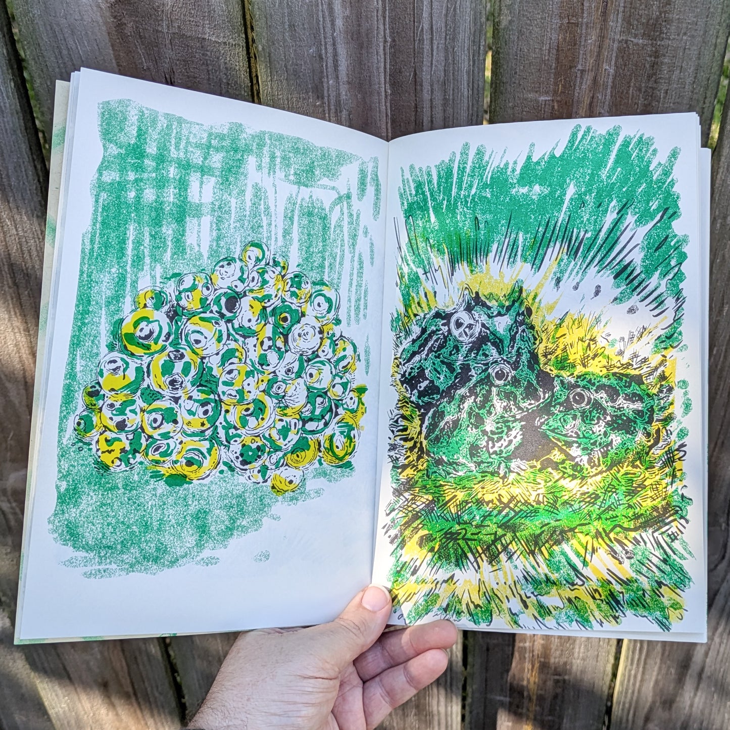 Zine spread with abstract frog eggs and pile of menacing frogs