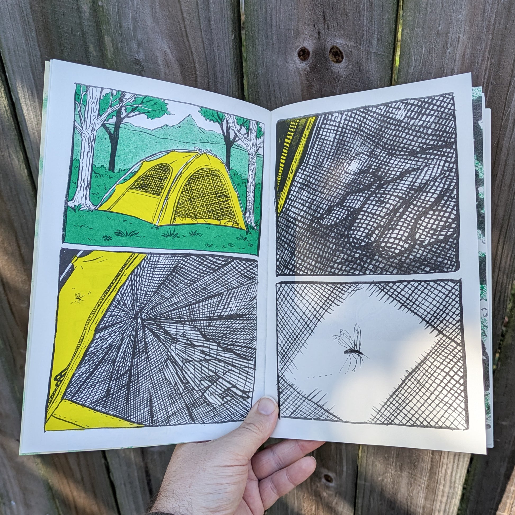 Open zine with illustrations of a tent and mosquito entering a hole in the netting 