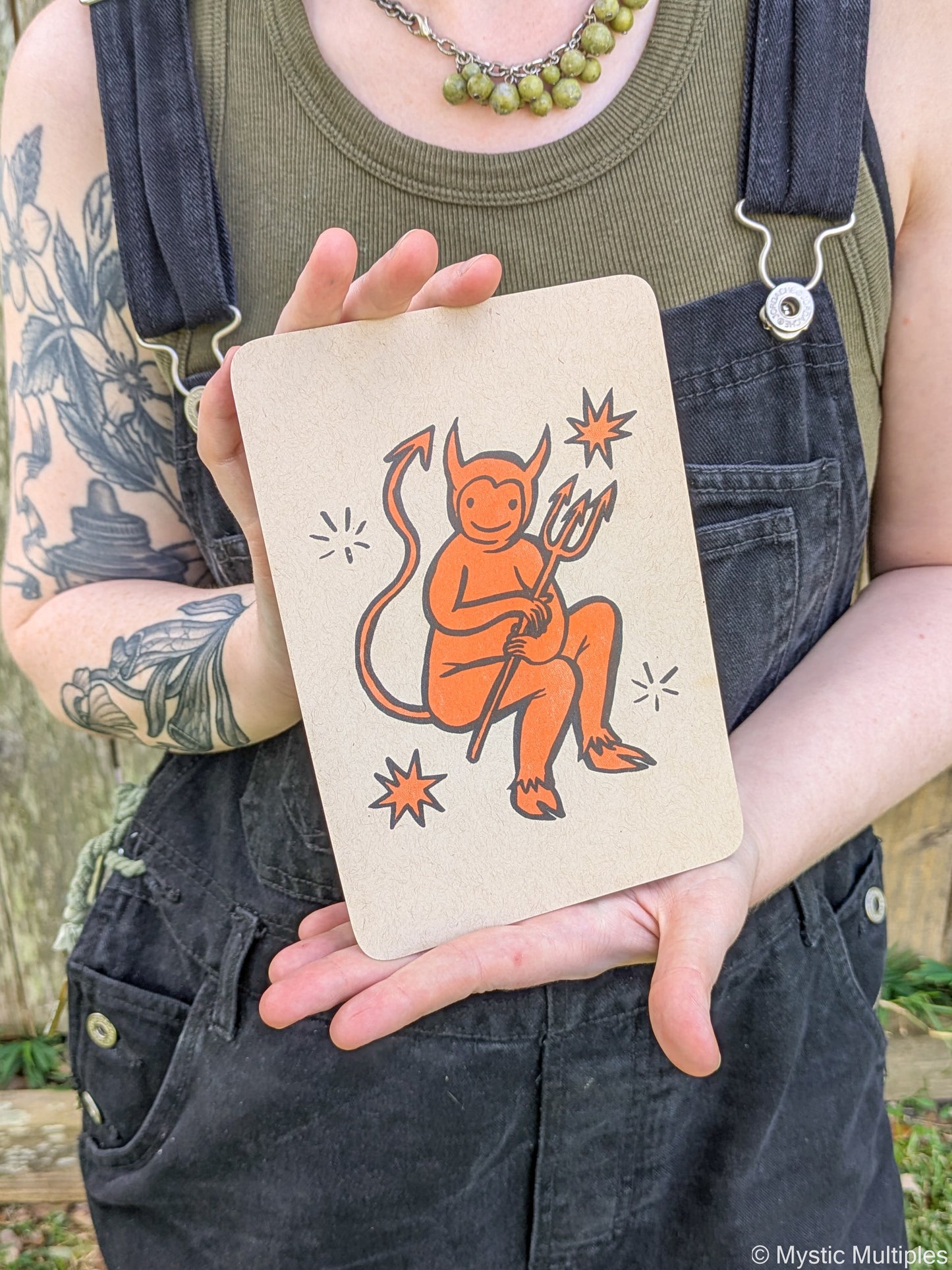 Person holding the tiny devil cards