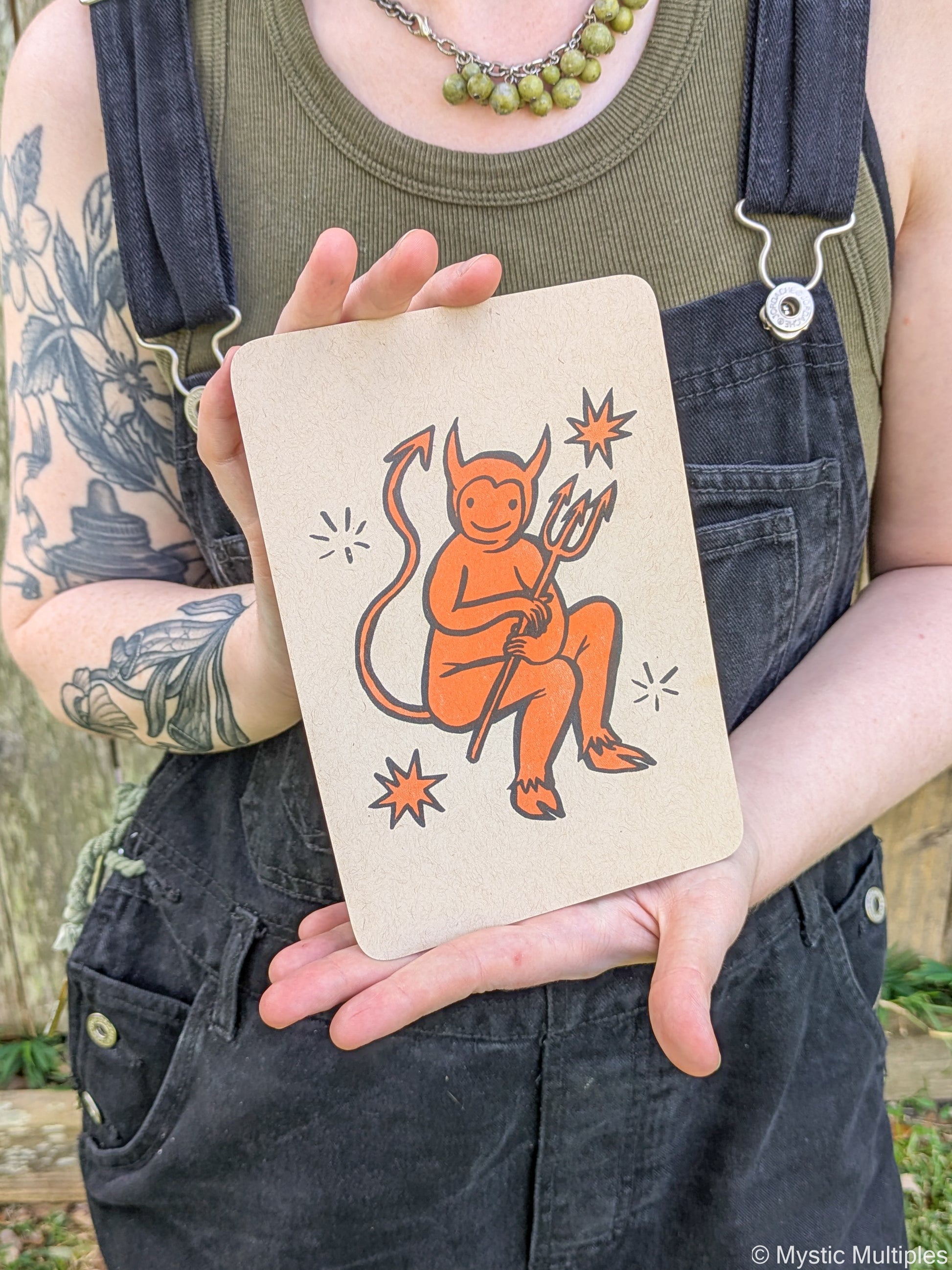 Person holding the tiny devil cards